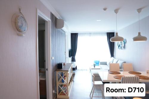 a living room with a table and chairs and a room at My Resort Hua Hin - by Great Days in Hua Hin