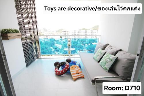 a living room with a couch and toys on the floor at My Resort Hua Hin - by Great Days in Hua Hin