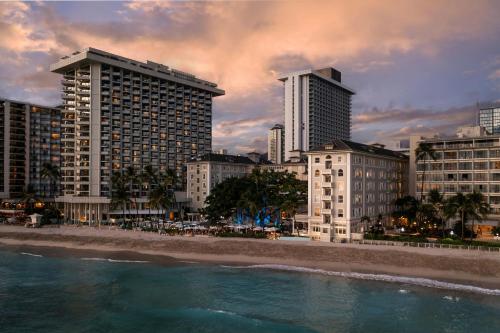 a city with tall buildings and a beach with water at Moana Surfrider, A Westin Resort & Spa, Waikiki Beach in Honolulu