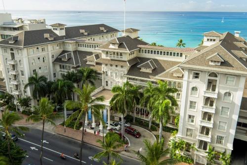 an aerial view of a building with palm trees and the ocean at Moana Surfrider, A Westin Resort & Spa, Waikiki Beach in Honolulu
