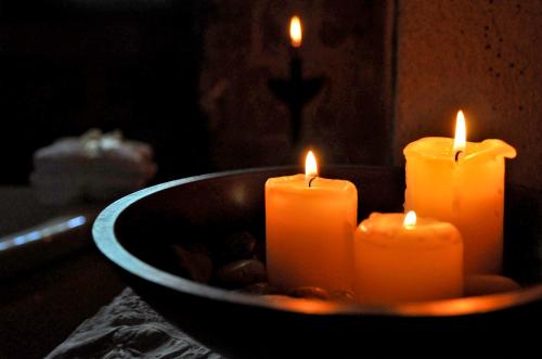 a group of candles sitting in a bowl at S.Nikolis' Historic Boutique Hotel in Rhodes Town
