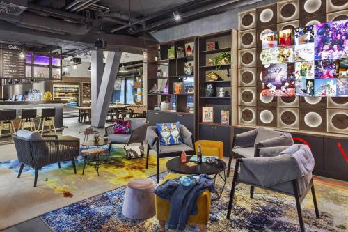 a store with chairs and tables in a room at Moxy Lausanne City in Lausanne