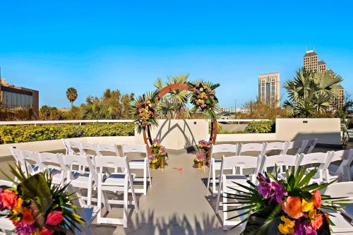 a set up for a wedding with white chairs and flowers at Marriott Orlando Downtown in Orlando