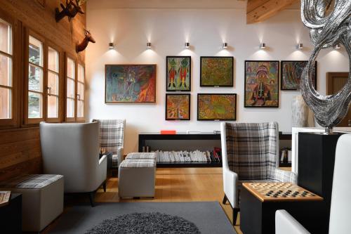 a room with chairs and paintings on the wall at Le Strato in Courchevel