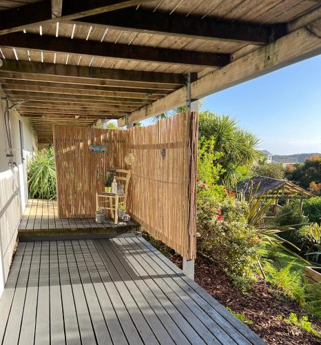 a wooden deck with a wooden pergola at Tutukaka Sunrise in Tutukaka