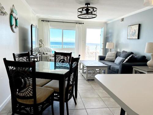 a kitchen and living room with a table and chairs at Aqua Villa Condo 204 Beachfront in Fort Walton Beach