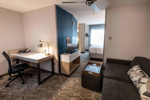 a hotel room with a desk and a bed at SpringHill Suites Columbus Airport Gahanna in Gahanna