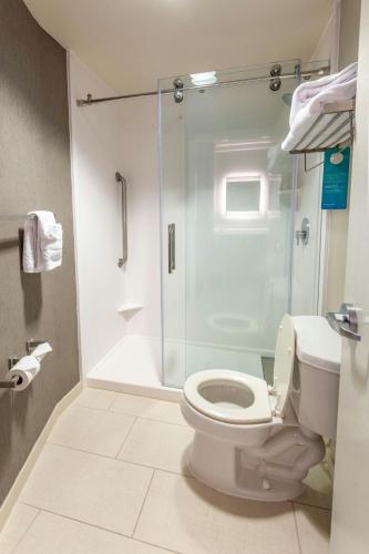 a bathroom with a toilet and a glass shower at SpringHill Suites Columbus Airport Gahanna in Gahanna