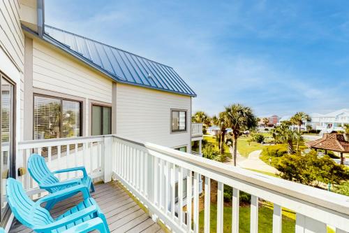 two blue chairs on a porch with a view of the ocean at Plantation West #1348 in Gulf Shores