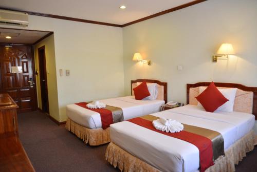 Ένα ή περισσότερα κρεβάτια σε δωμάτιο στο Angkor Hotel