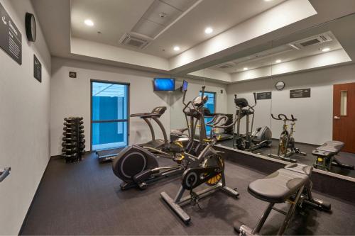 a gym with several tread machines and a mirror at City Express by Marriott La Raza in Mexico City