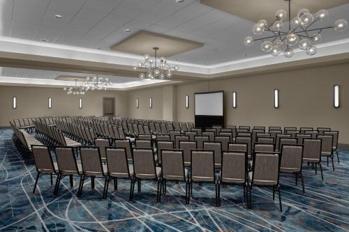 a room with rows of chairs and a podium at Sheraton Milwaukee Brookfield in Brookfield