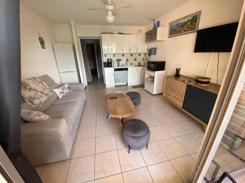 un salon avec un canapé et une table dans l'établissement Le Paradis Bleu, à Cavalaire-sur-Mer