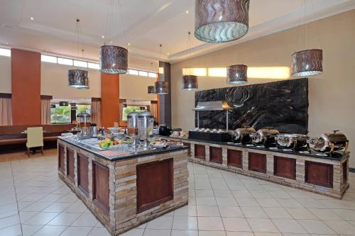a large kitchen with a counter with pots and pans at Protea Hotel by Marriott Chipata in Chipata