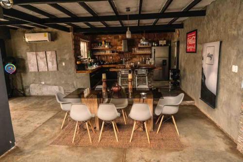 a dining room with a table and some chairs at Casa a pasos del mar de Playa el Agua in La Loma