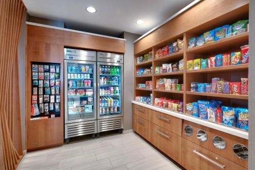 a kitchen with a refrigerator and lots of food at Springhill Suites by Marriott Colorado Springs North/Air Force Academy in Colorado Springs