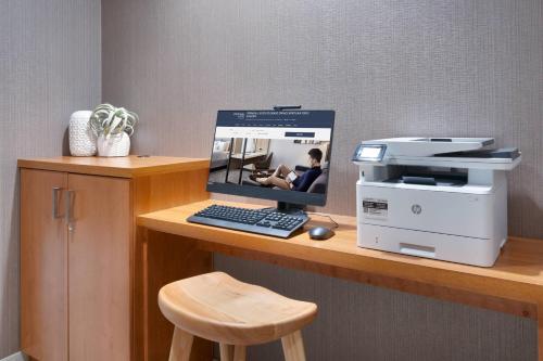 a computer sitting on a desk with a printer at Springhill Suites by Marriott Colorado Springs North/Air Force Academy in Colorado Springs