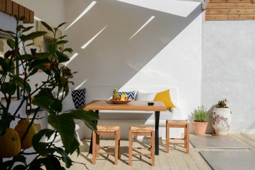 a table and chairs in a room with plants at Chrisanthi Elegant Villa in Pitsidia