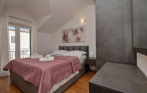 a bedroom with a bed with two towels on it at Villa Elizabeta Makarska by Villas Guide in Makar