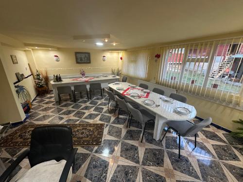 a dining room with a table and chairs in it at Pensiunea Daiana in Albac