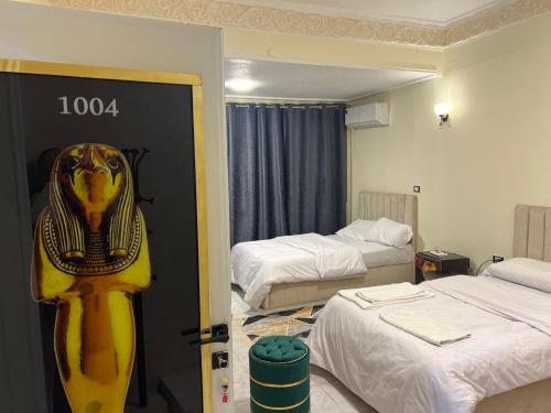 a hotel room with two beds and a lion head on the door at Miracle Pyramids View Hotel in Giza