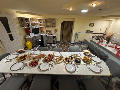 a long table with plates of food on it at Pensiunea Daiana in Albac