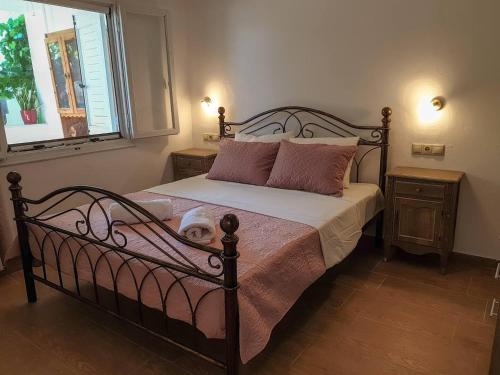 a bedroom with a bed with a dog laying on it at Maria's House, With Garden in Kalamaki Heraklion