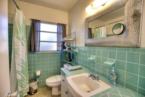 a bathroom with a sink and a toilet and a mirror at Retro-inspired Stay, Bbq Patio, Close To Downtown in Sarasota