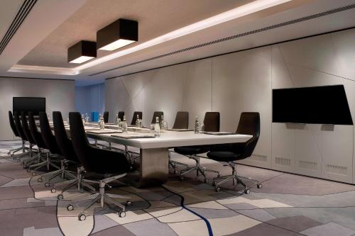 a conference room with a long table and chairs at Le Meridien Istanbul Etiler in Istanbul