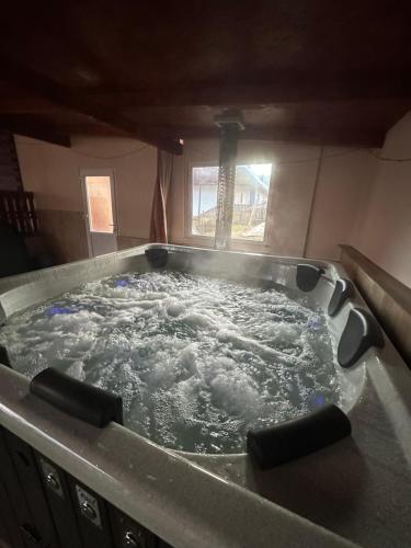 a large bath tub filled with water in a kitchen at Pensiunea Daiana in Albac