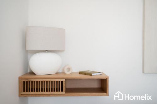 a table with a lamp on top of it at AMAYA - Sea View Suites in Chalkida