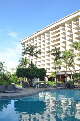a hotel with a pool in front of a building at Hotel Princess Mundo Imperial Riviera Diamante Acapulco All Inclusive in Acapulco