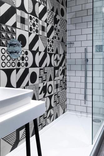 a bathroom with a shower and a white sink at Abbey Hotel Bath, a Tribute Portfolio Hotel in Bath