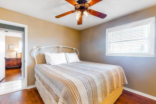 a bedroom with a bed with a ceiling fan at Bay Dream Believer in Dauphin Island