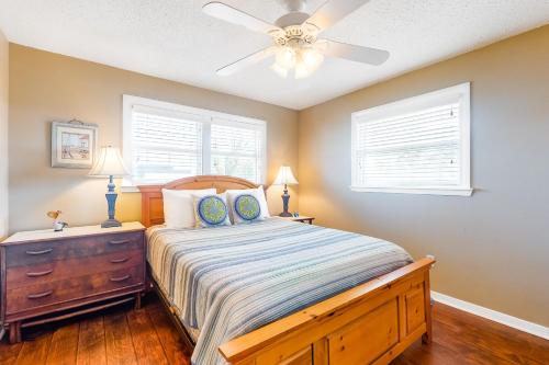 a bedroom with a bed and a ceiling fan at Bay Dream Believer in Dauphin Island