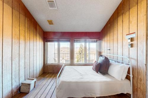 a bedroom with a bed in a room with a window at Mountainside 037 in Granby