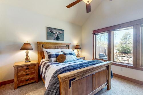 a bedroom with a wooden bed and a window at Running Bear & Buffalo Run in the Rockies (Master Listing) in Estes Park