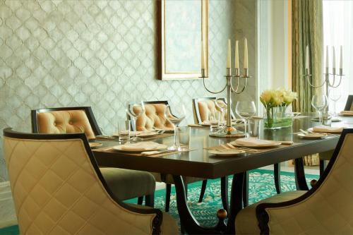 a dining room with a long table and chairs at The St. Regis Abu Dhabi in Abu Dhabi