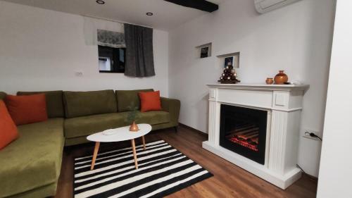 a living room with a couch and a fireplace at Вивиан - модерна вила за гости in Reselets