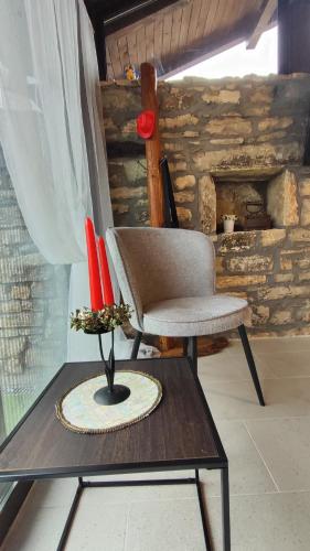 a chair and a vase on a table in a room at Вивиан - модерна вила за гости in Reselets