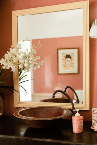 a bathroom sink in front of a mirror at Dar Jedeti Khadija in Hergla