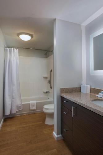 a bathroom with a toilet and a sink and a shower at TownePlace Suites by Marriott Monroe in Monroe