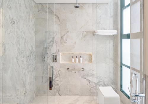 a bathroom with a shower with a toilet and a sink at Boa Vista Surf Lodge in Pôrto Feliz