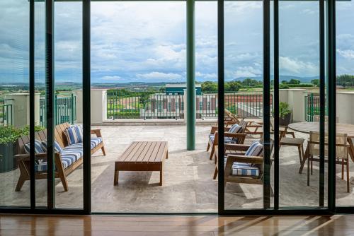 a view of a balcony with chairs and tables at Boa Vista Surf Lodge in Pôrto Feliz