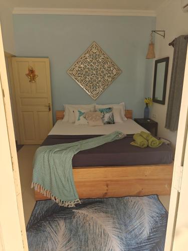 a bedroom with a large bed with a wooden frame at SOLS Backyard in Arambol