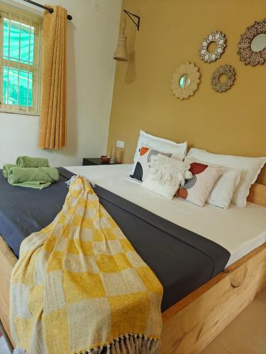 a bedroom with a bed with a blanket on it at SOLS Backyard in Arambol