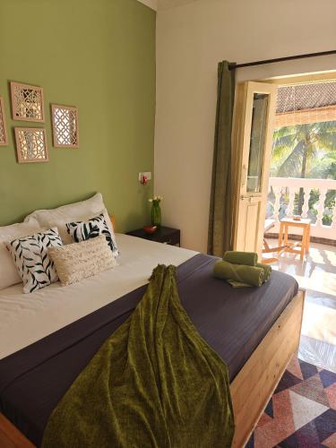 a bedroom with a bed and a window with a patio at SOLS Backyard in Arambol