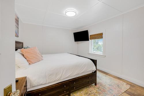 a bedroom with a bed and a tv on the wall at Oceanside Skies - Main House in Oceanside