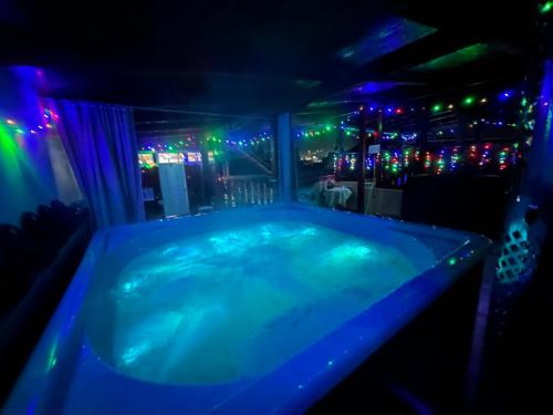 a jacuzzi tub in a room with lights at Pensiunea Daiana in Albac