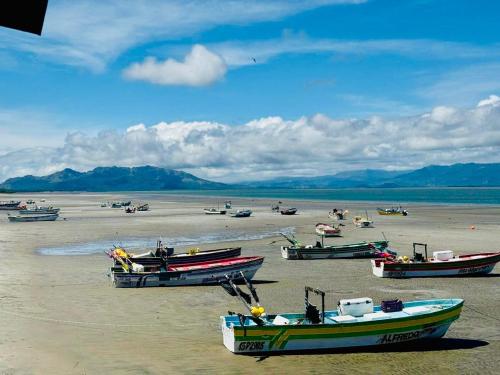 a group of boats sitting on the beach at Beach Resort Entire Home in El Quindio